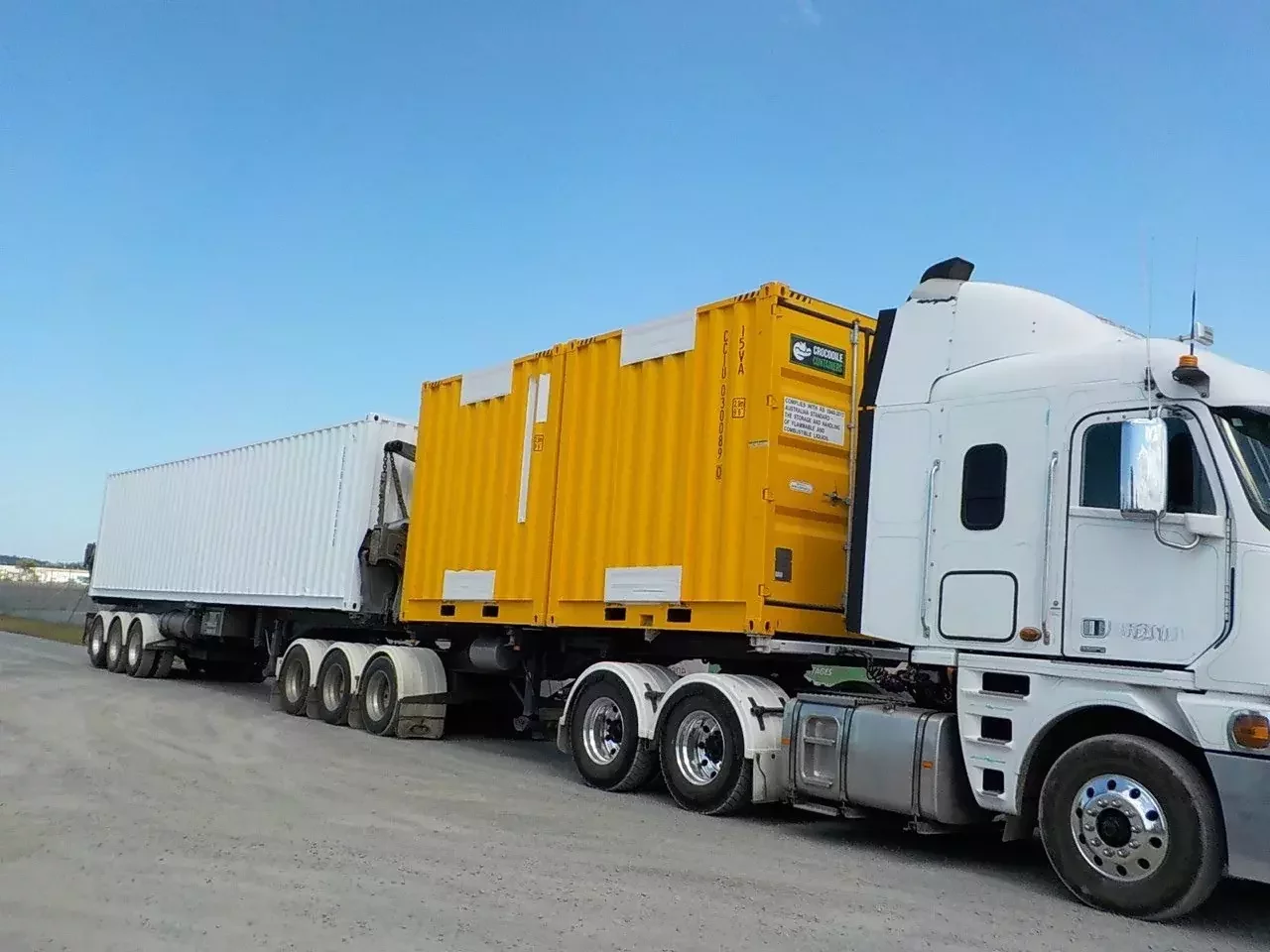 Shipping containers loaded on a transport truck for delivery from Crocodile Containers in Brisbane